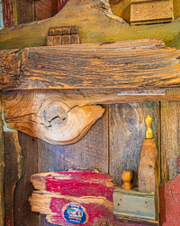 An entrance door becomes a work of art, a still life composed of fading paint, commercial lithography, wood turnings, and the dramatic granularity of wood.