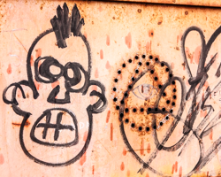 A wild-eyed, wild-haired caricature adds emotional tension and humor to this mural.