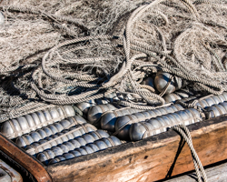 Gill nets and floats in their weathered wood box reflect the care of an orderly fisherman.