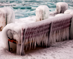 An icy bench provides the perfect viewpoint for admiring the icy bay.