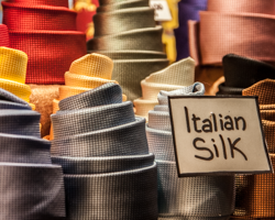 Silk neckties line up like little Pisa towers in a Venetian display window.