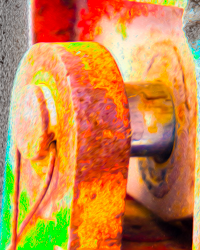 Paint and rust decorate machinery in rainbow patterns.